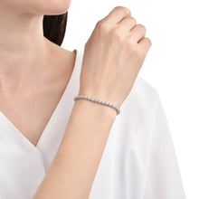 Load image into Gallery viewer, Elegant model hand showcasing the intricate details of our Moissanite Round Bracelet gift for her 