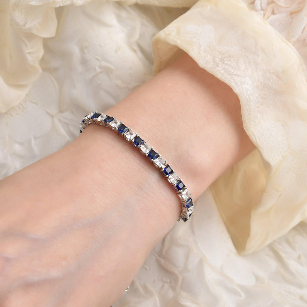 Elegant model hand showcasing the intricate details of our Blue White Tennis Bracelet Lab-Grown Blue and White Square Sapphire Bracelet silver bracelet