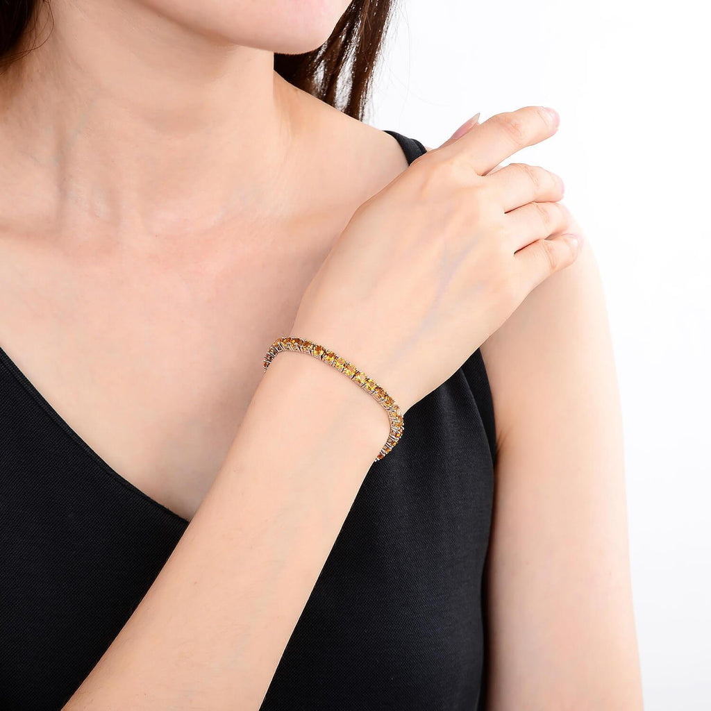 Elegant model hand showcasing the intricate details of our silver bracelet Petite Sterling Silver Citrine Bracelet, $ 200 - 300, Citrine, Round, Yellow, 925 Sterling Silver, Tennis