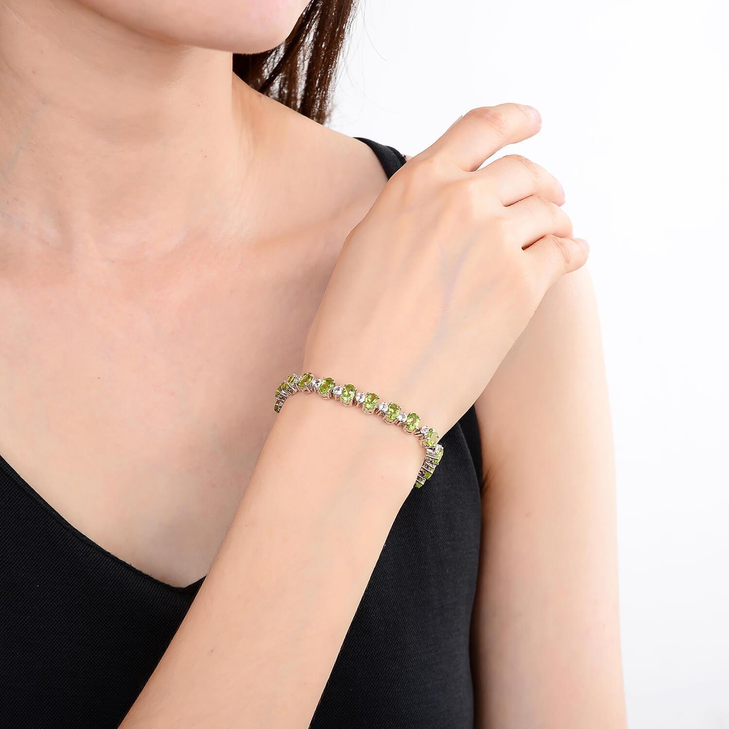 Elegant model hand showcasing the intricate details of our silver bracelet Sterling Silver Peridot Bracelet, $ 200 - 300, Peridot, Pear, Green, 925 Sterling Silver, Tennis