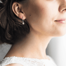 Load image into Gallery viewer, model showcasing Peridot earrings silver earrings rhodium earrings peridot hoops hoop earrings cute dainty earrings dainty hoop earrings cute hoop earrings dainty peridot silver hoop earrings green stone earrings office wear jewelry work wear earrings