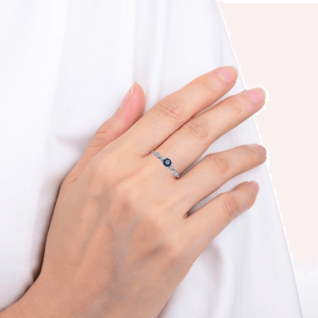 Model wearing sapphire ring, elegant blue sapphire ring, model in blue sapphire ring